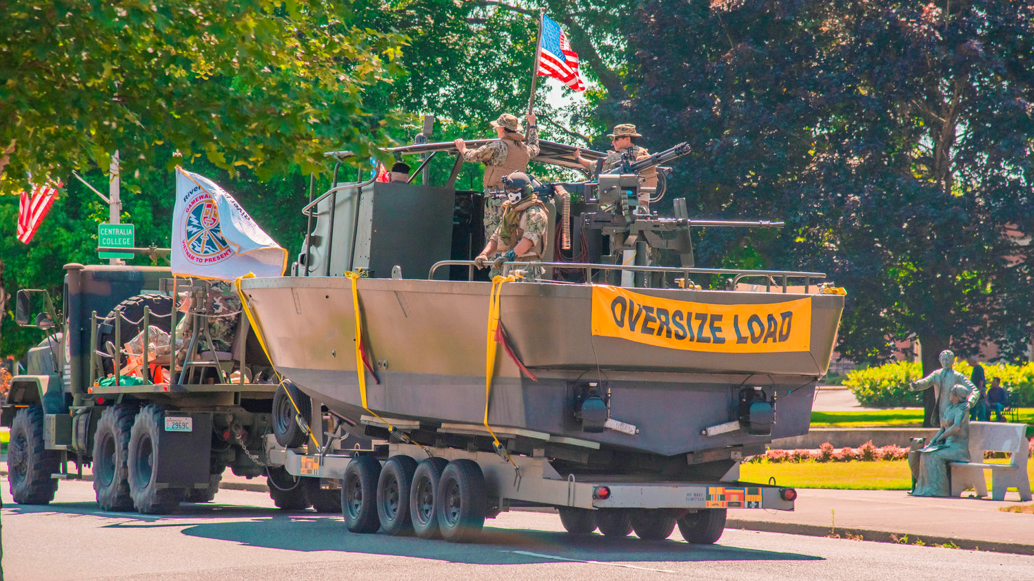 A Vietnam Era PBR boat is pulled behind a military vehichle as they move through downtown Centralia during a “Patriotic Drive,” Sunday afternoon.